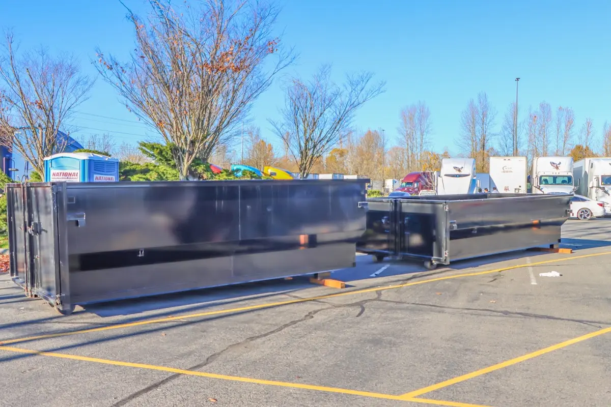 Professional dumpster rental service with roll-off container on residential driveway in Camino Tassajara